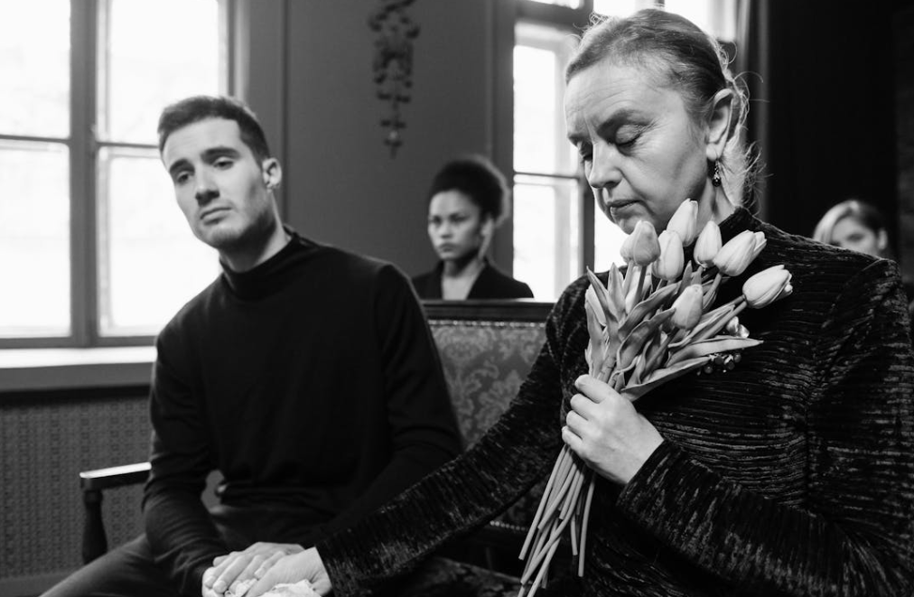 Family members supporting one another at a funeral
